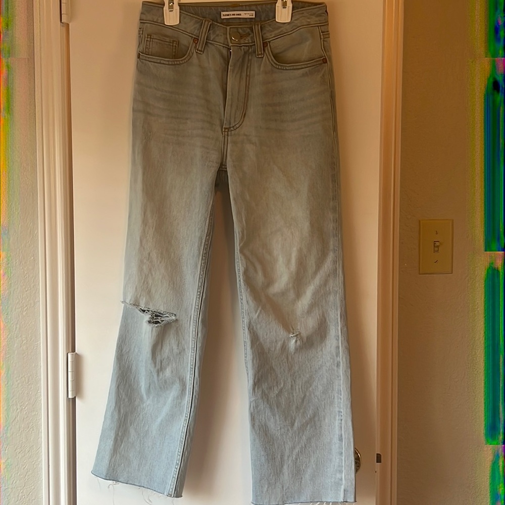 Light colored light distress jeans.